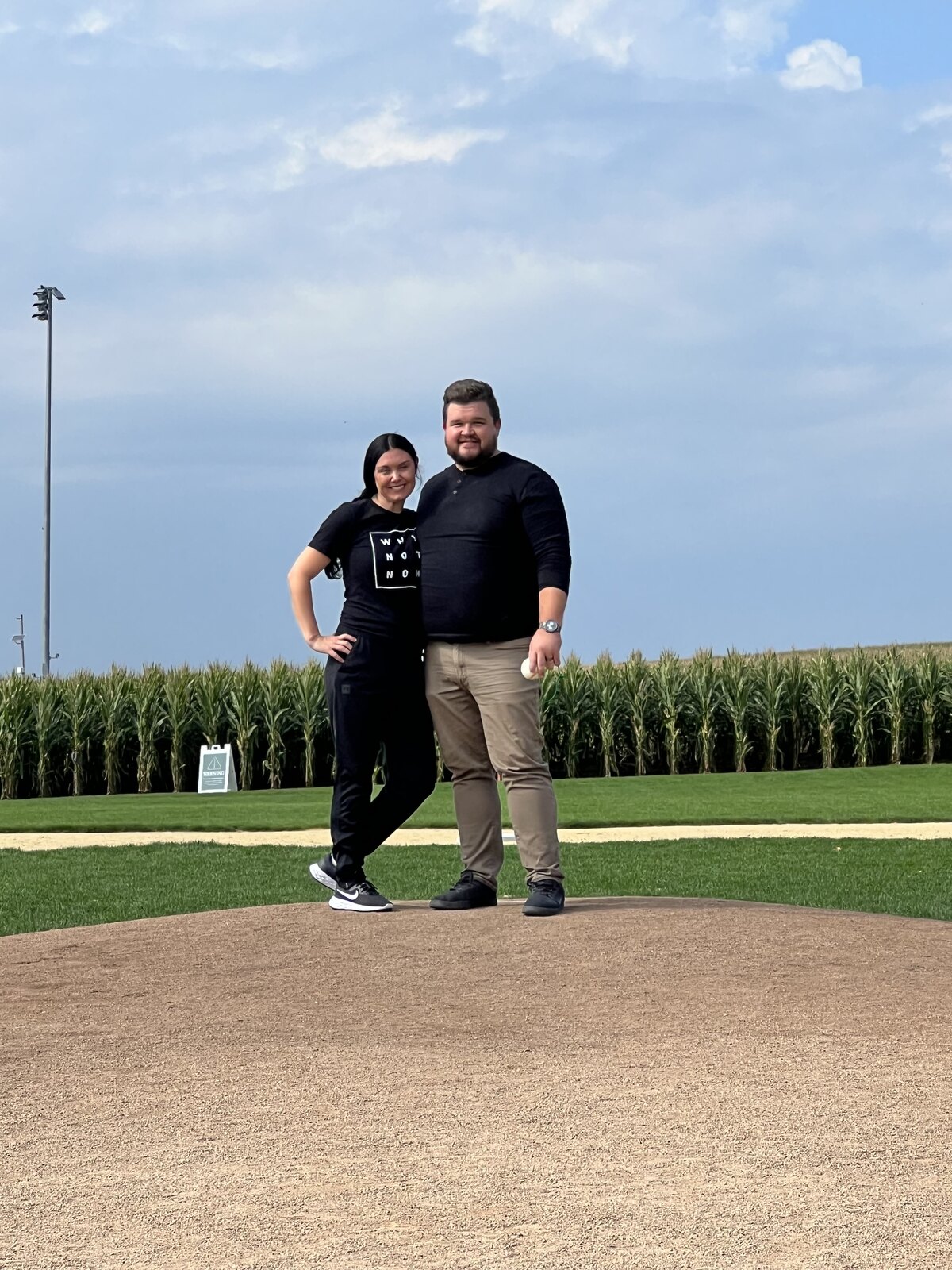 Dana and Juliet Wright on a ballfield surrounded by Nebraska corn